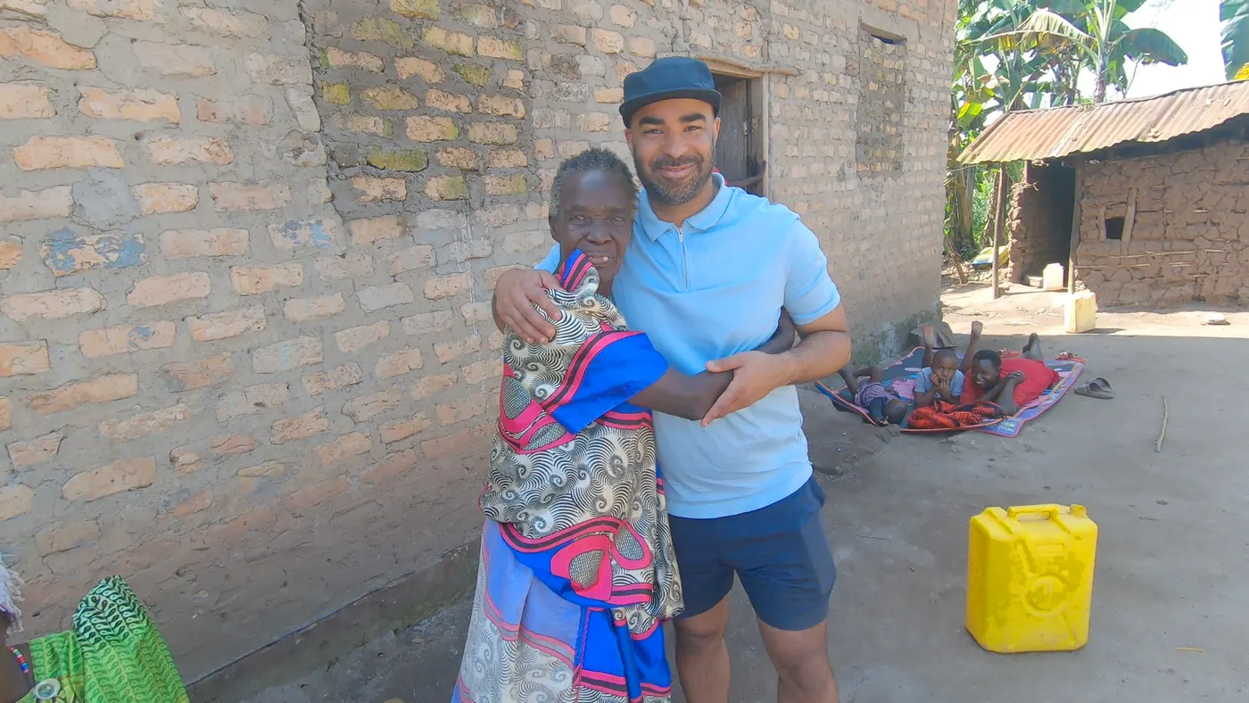 TJ with a friend in a village in Uganda